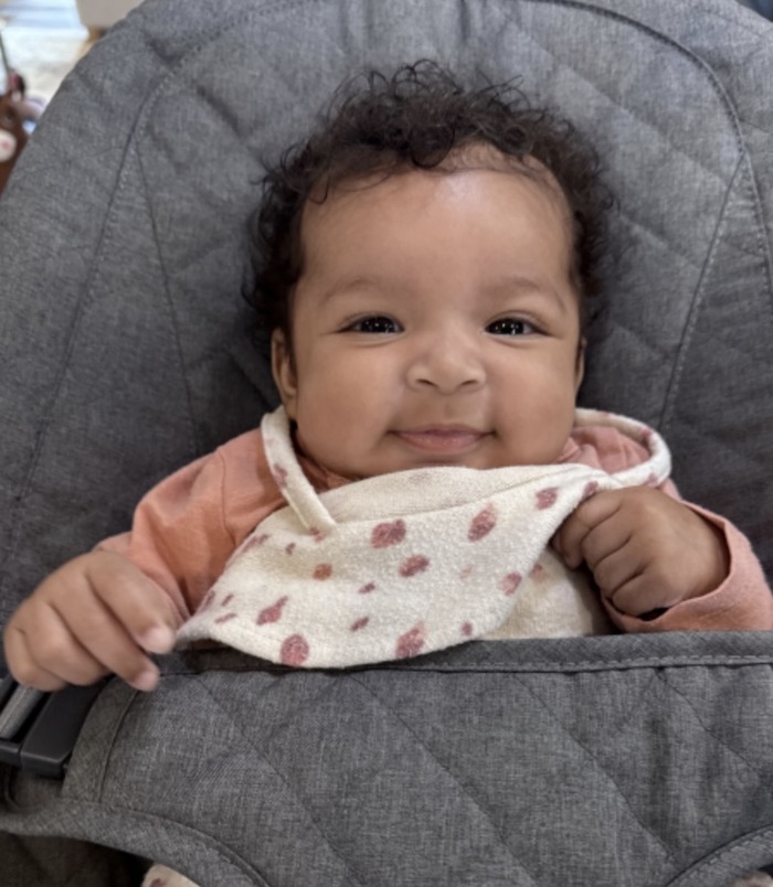 Smiling infant enjoying indoor care at Kido Heaven - Childcare Bothell with a warm and nurturing environment.
